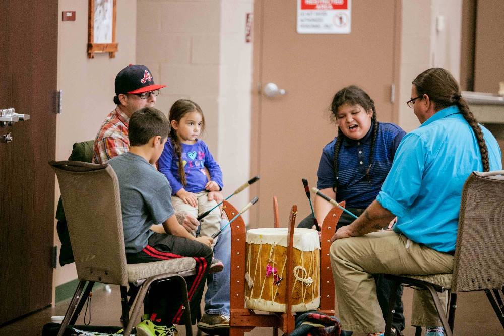 Children learning to play drums